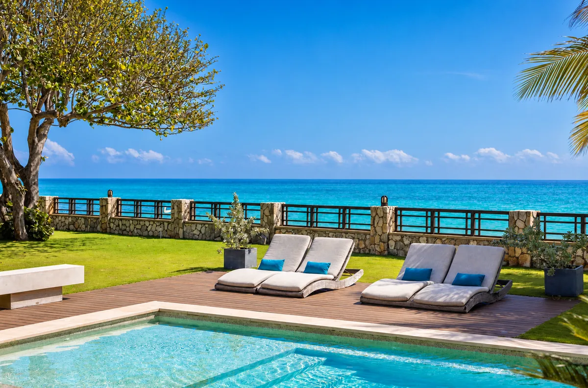 Poolside loungers on an oceanfront villa terrace in Jamaica