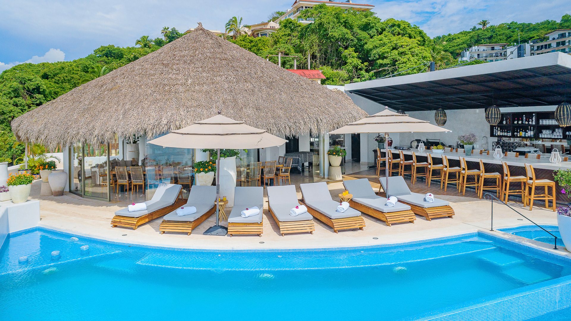 Poolside terrace and palapa at a Puerto Vallarta villa