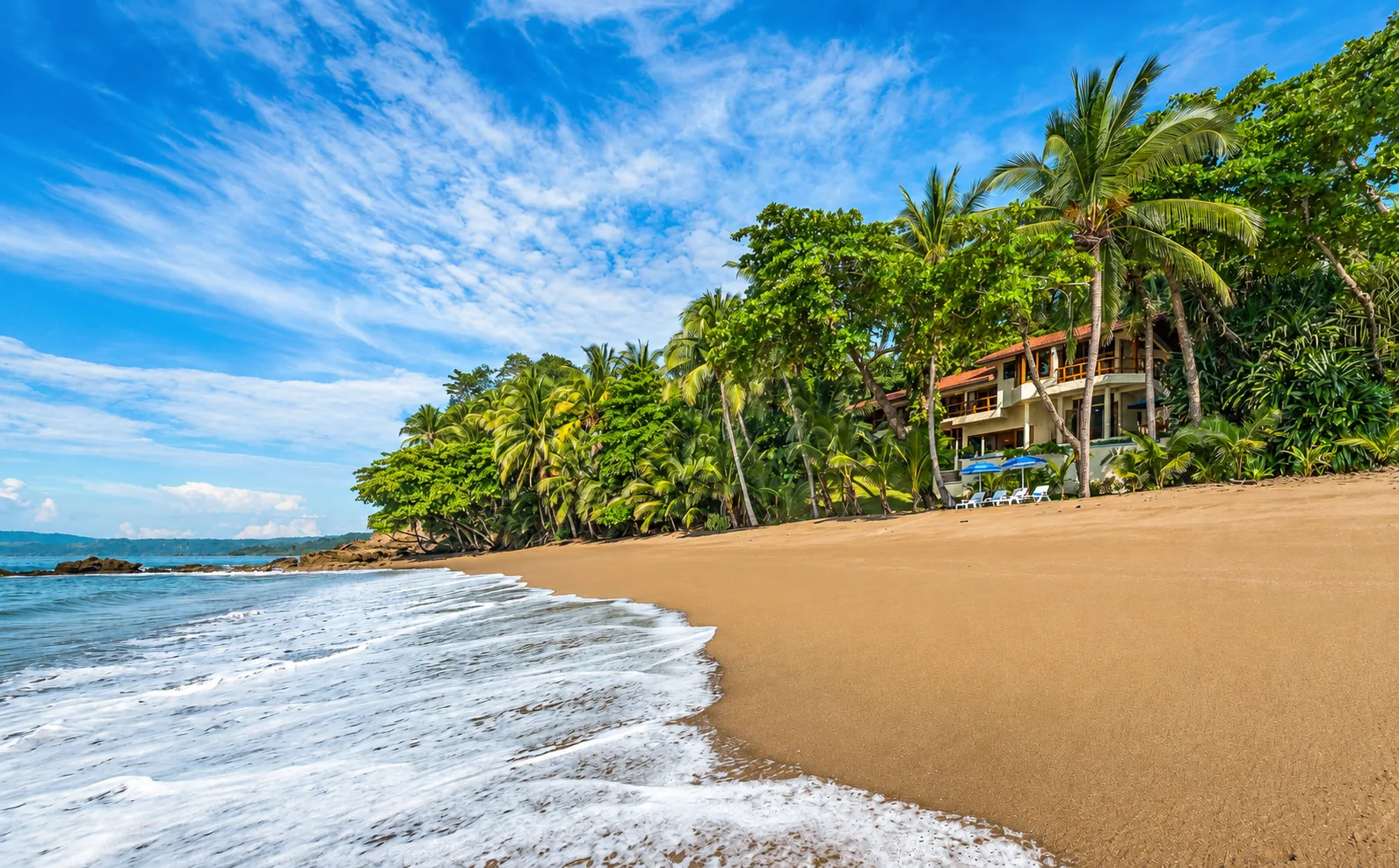 A beachfront villa among palms beside the Pacific in Costa Rica