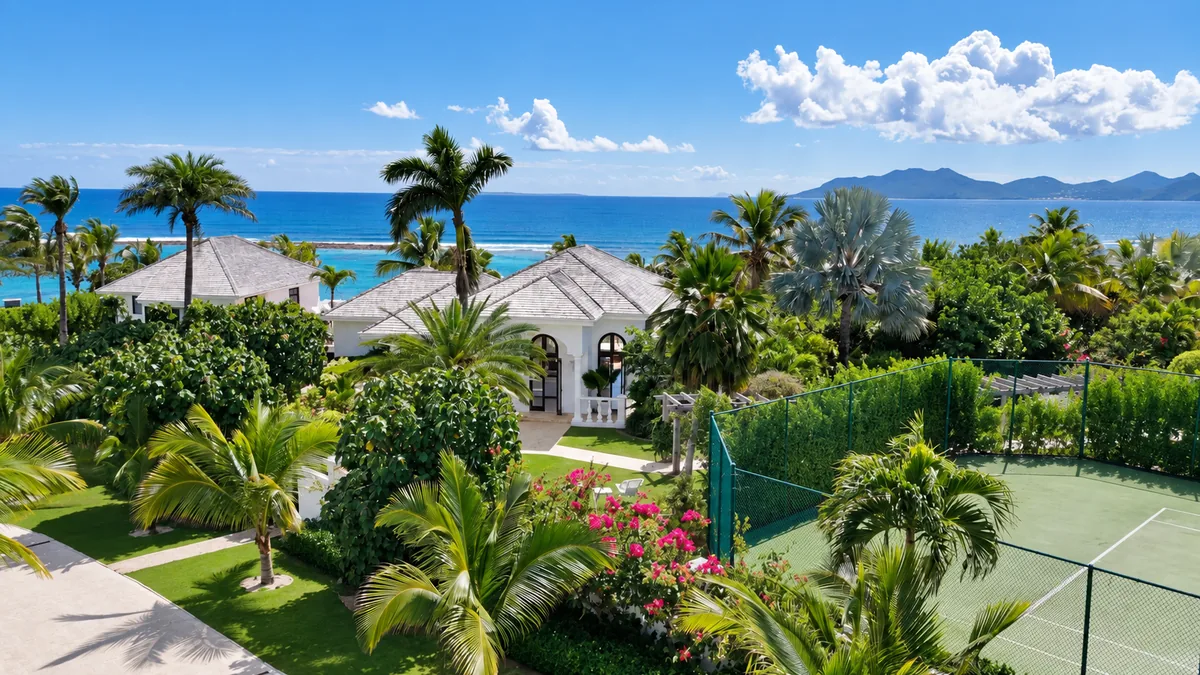 Tropical villa gardens and a tennis court overlooking the Caribbean Sea