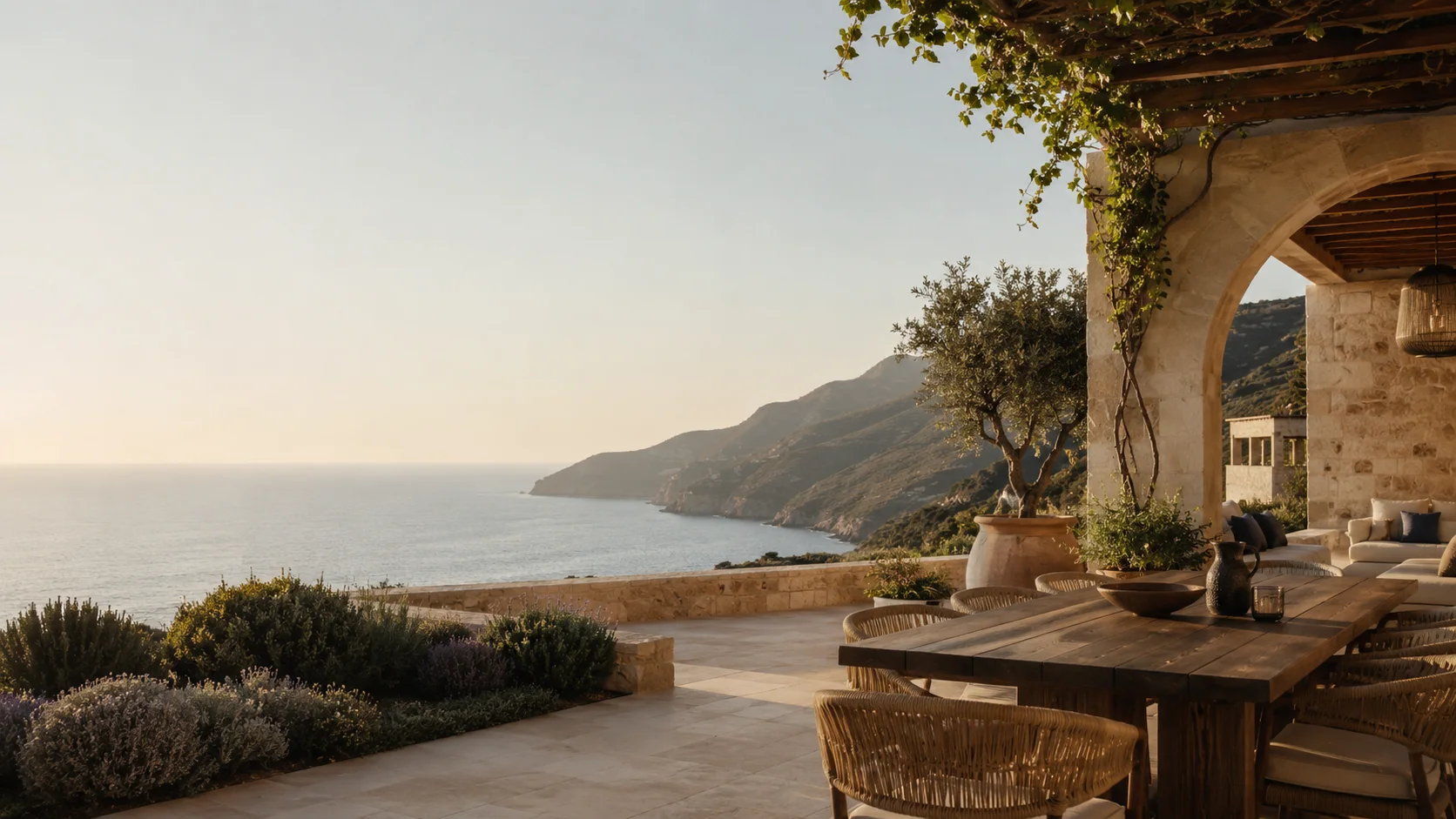 A sunlit private villa terrace overlooking the sea and mountains